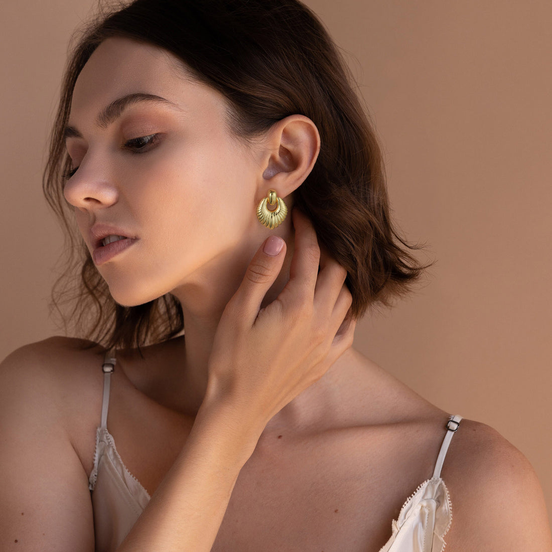 Golden, oval-shaped leaf earrings