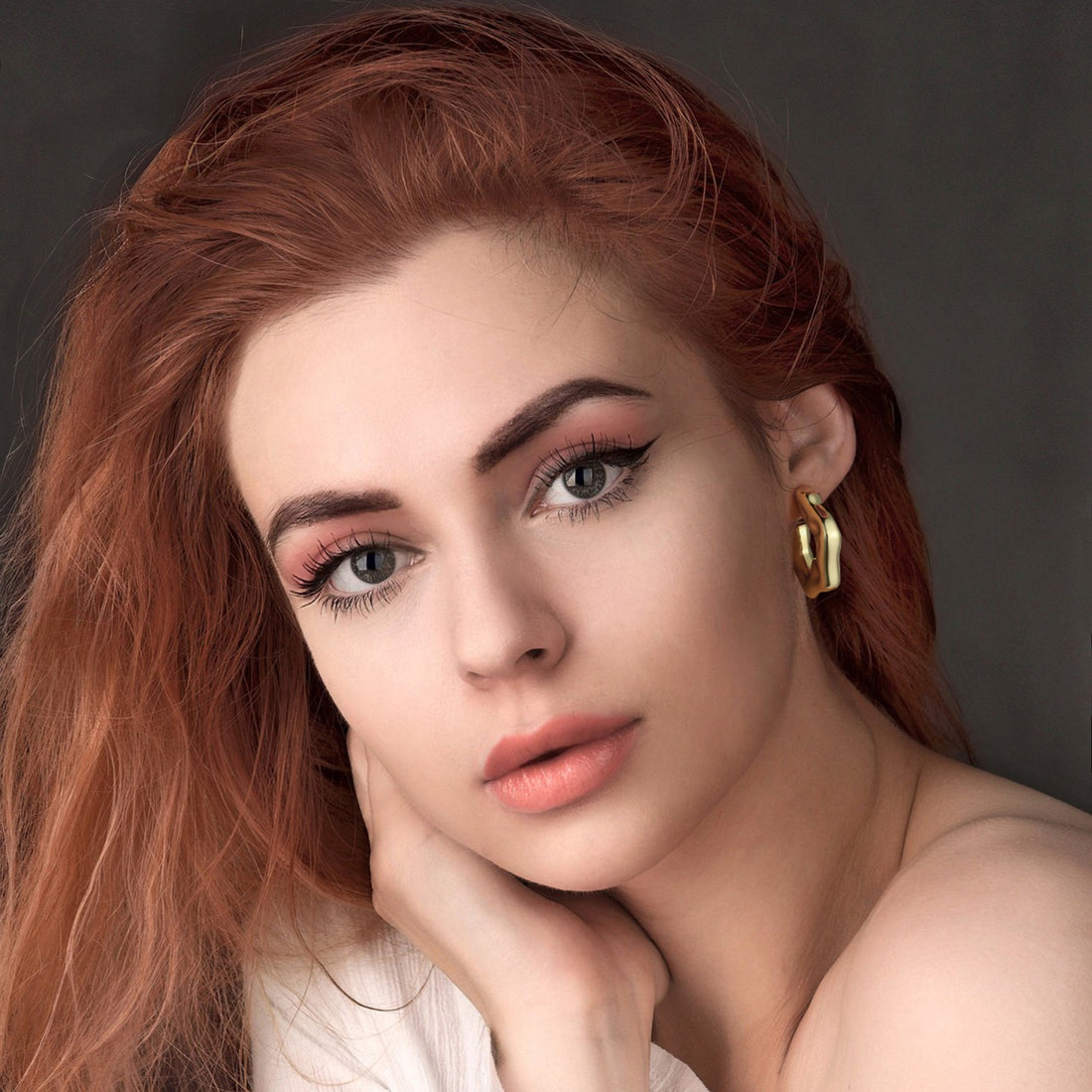 Golden-colored, large C-shaped thick earrings