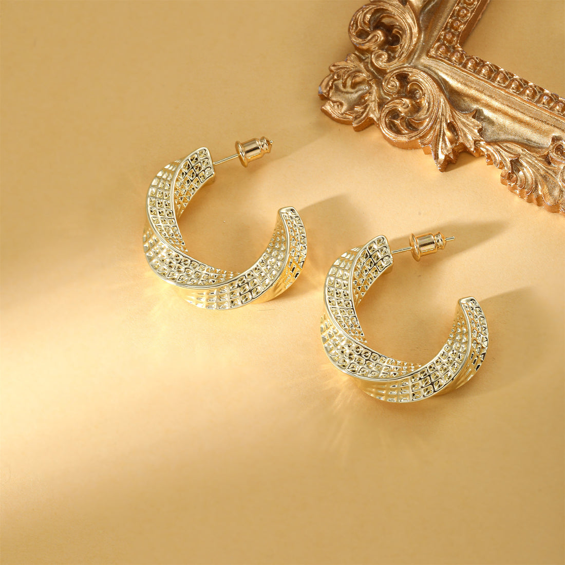 Golden-colored earrings with various patterns and designs