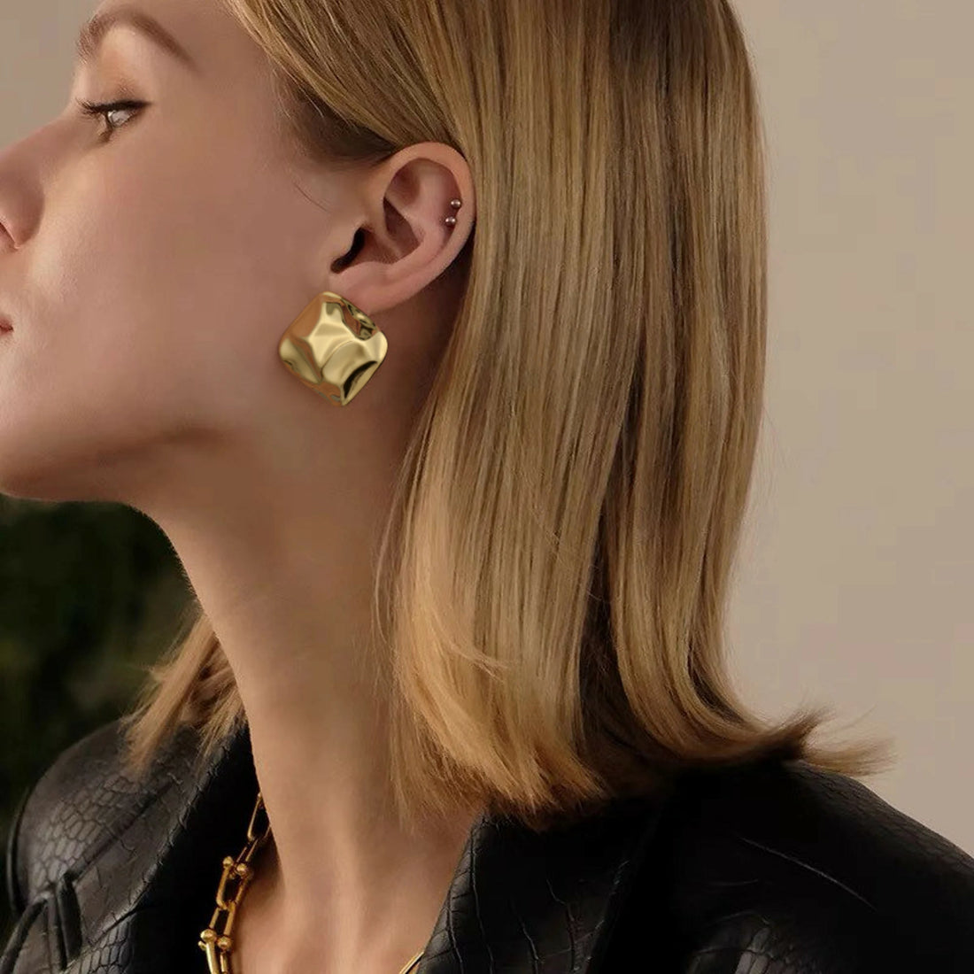 Golden, round earrings with concave and convex texture